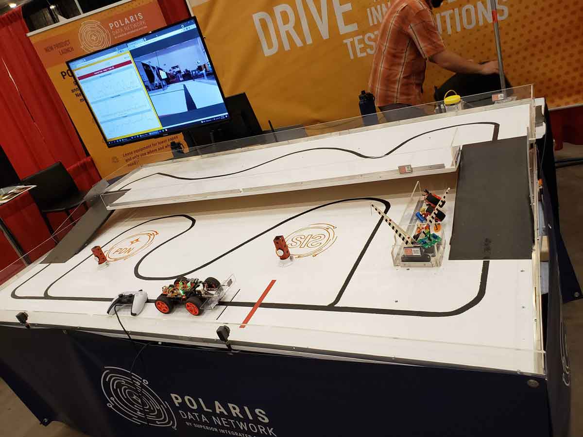Superior Integrated Systems booth at Advance Manufacturing Expo with remote car to display features of Polaris Data Network
